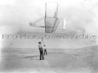 Dan Tate and Wilbur Wright flying glider as kite