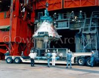 Fire-ravaged Apollo 204 command module is lowered from the gantry at 