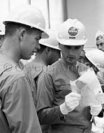 Crew for the Apollo 204 mission inspect spacecraft equipment