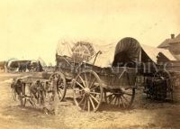 Covered wagon with sign, 1865
