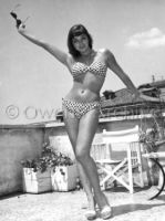 Joan Collins wearing a bikini
