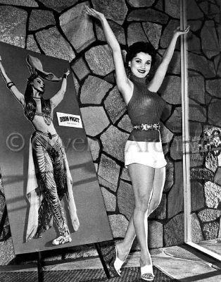 Debra Paget wearing shorts and high heels