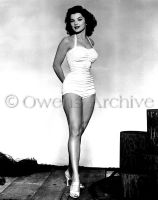 Debra Paget wearing swimsuit and high heels