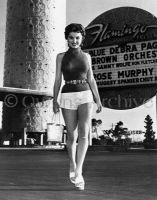 Debra Paget wearing shorts and high heels
