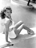Rita Hayworth wearing swimsuit at her home