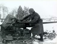 Soldier with 1st Infantry next to 40-mm Antiaircraft Gun
