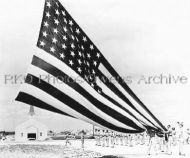Soldier Unfolding Large Garrison Flag at Fort Hood
