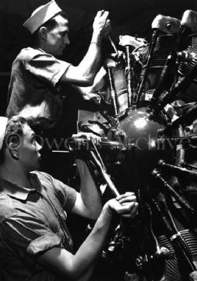 Aviation Machinists Working on Aircraft Engine