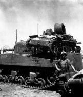 Japanese tank sits on Sherman Tank