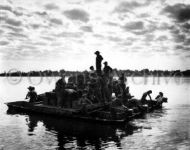 Soldiers cross the Irrawaddy River in barge