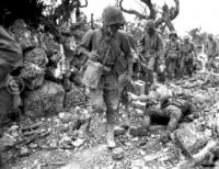 Marines pass through village on Okinawa