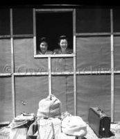 Two Women Looking Out of Window 