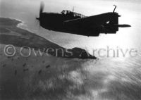 TBM Avenger bomber flies near Mount Suribachi 