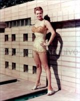 Esther Williams wearing swimsuit and high heels