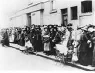 Women and children in bread line, London