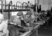 Women workers use pneumatic hammers