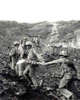 Marines carry first American flag up Mount Suribachi, Iwo Jima